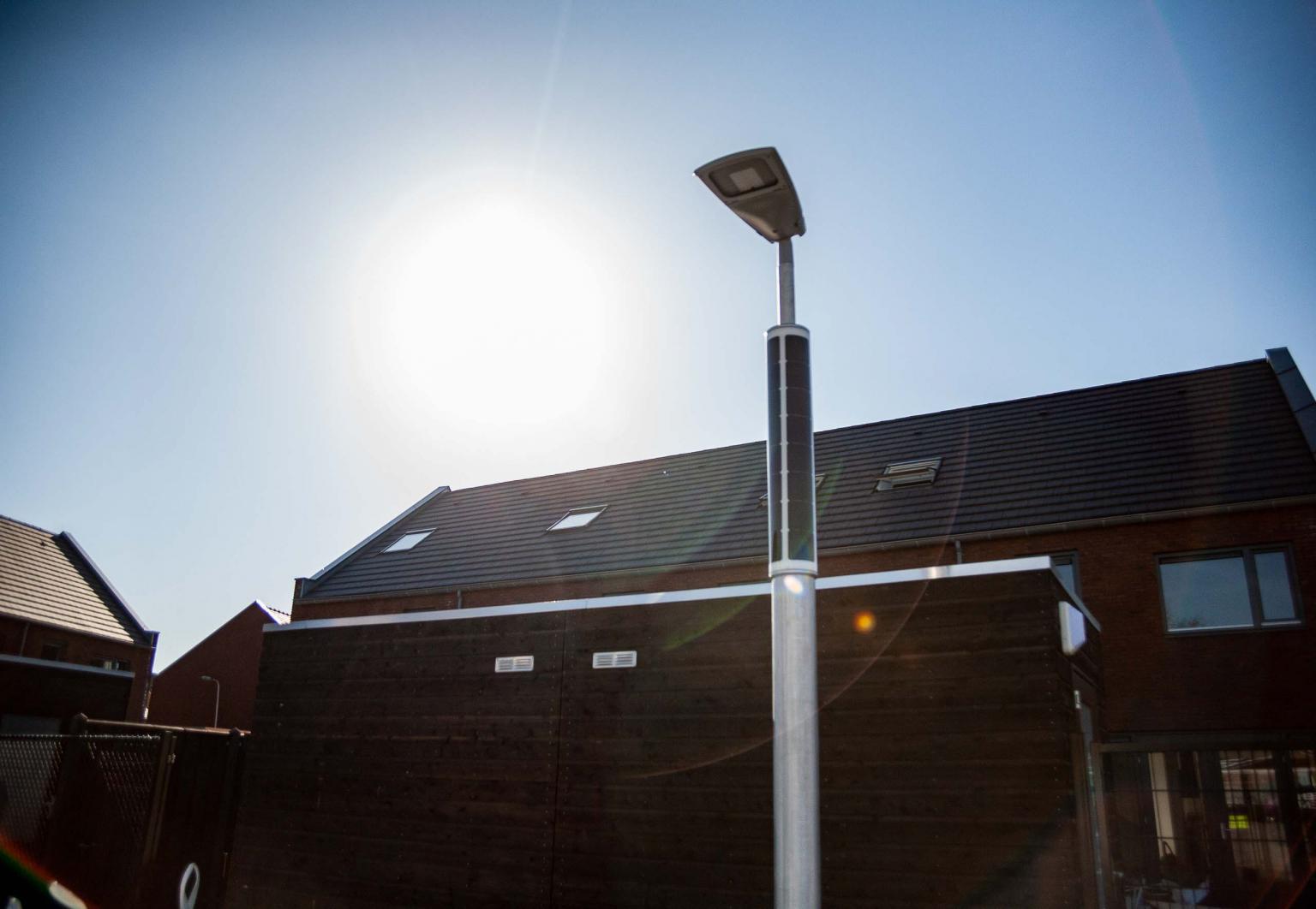 Solar powered parking lot lighting with the sun shining Solar powered parking lot lighting with the sun shining